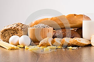 Fresh bread, eggs and glass of milk and grains.