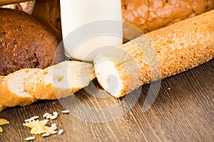 Fresh bread, eggs and glass of milk and grains.