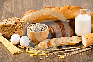 Fresh bread, eggs and glass of milk and grains.
