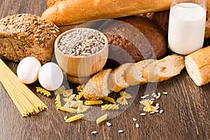 Fresh bread, eggs and glass of milk and grains.