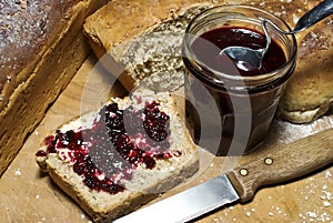 Fresh bread and homemade fruit preserve photo