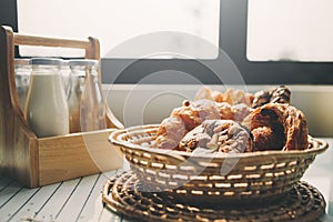 Fresh bread on the kitchen table with beverage at morning