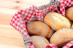 Fresh bread rolls in a rustic picnic basket