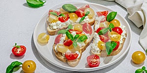 Fresh bread sandwiches with tomato cherry, cream cheese and basil leaves. Morning breakfast concept