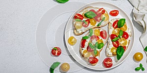 Fresh bread sandwiches with tomato cherry, cream cheese and basil leaves. Morning breakfast concept