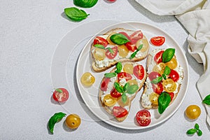 Fresh bread sandwiches with tomato cherry, cream cheese and basil leaves. Morning breakfast concept