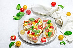 Fresh bread sandwiches with tomato cherry, cream cheese and basil leaves. Morning breakfast concept