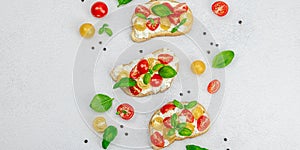 Fresh bread sandwiches with tomato cherry, cream cheese and basil leaves. Morning breakfast concept