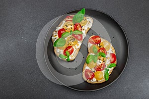 Fresh bread sandwiches with tomato cherry, cream cheese and basil leaves. Morning breakfast concept