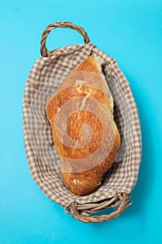 fresh bread in small backet on blue background