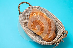 fresh bread in small backet on blue background