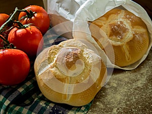 Fresh bread and tomatoes on a table