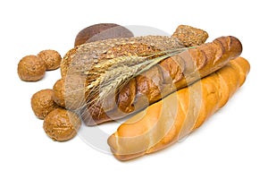 Fresh bread and wheat ears on white background