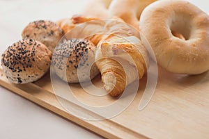 Fresh bread on the wooden board and white background