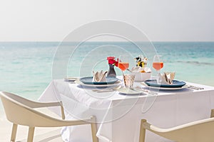 Fresh breakfast in a beautiful location with sea views. Luxury summer vacation or honeymoon destination, couple love together