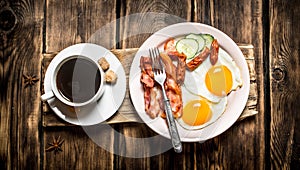 Fresh Breakfast. Cup of coffee , fried bacon with eggs