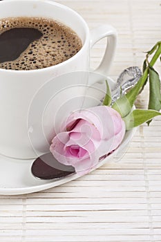 Fresh brewed coffee and a rose