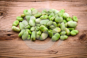 Fresh broad bean on old wooden photo