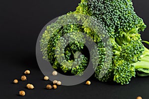 Fresh broccoli and coriander on black background. Close up. Healthy food