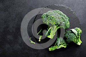 Fresh broccoli florets on black background