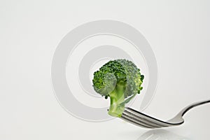 Fresh broccoli on fork