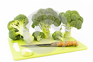 Fresh broccoli with scared cartoon style faces on white background