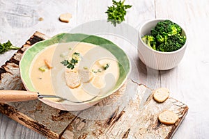 Fresh broccoli soup with croutons and herbs, Food recipe background. Close up