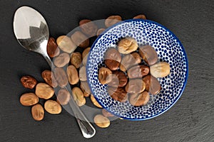 Fresh brown bean on grey stone