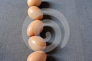 Fresh brown chicken eggs on grey background