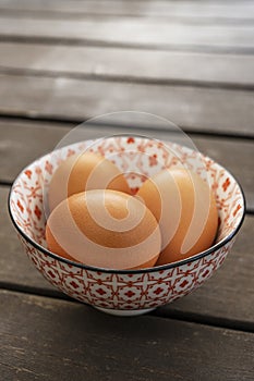 Fresh brown eggs in a beautiful bone china bowl