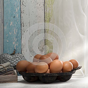 Fresh brown eggs in a pan