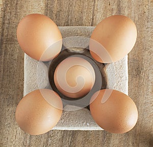 Fresh brown eggs on table.