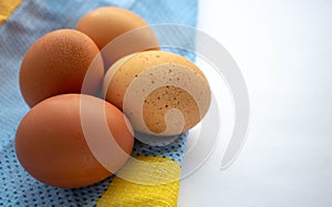 Fresh brown eggs on a towel. Easter concept