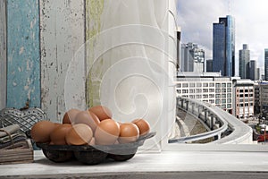 Fresh brown eggs on window sill, in the city