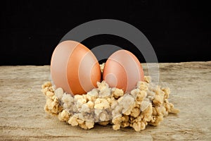 Fresh brown eggs on wood background