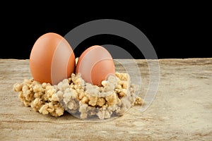 Fresh brown eggs on wood background