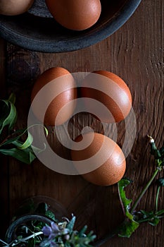 Fresh brown eggs on wooden background. Top view. Close up.