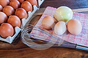 Fresh brown and white chicken eggs on a plate on wooden background