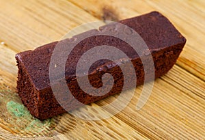 Fresh brownie on wooden table