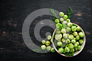 Fresh Brussels cabbage on a black background. Vegetables.