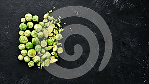 Fresh Brussels cabbage on a black background. Vegetables.