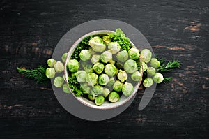 Fresh Brussels cabbage on a black background. Vegetables.