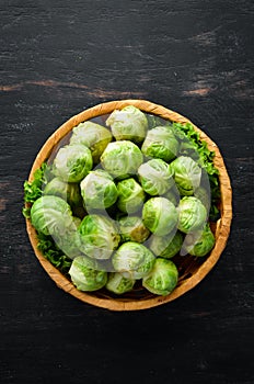 Fresh Brussels cabbage on a black background. Vegetables.