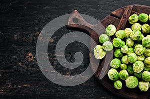 Fresh Brussels cabbage on a black background. Vegetables.