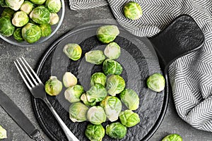 Fresh Brussels sprouts on grey table, flat lay