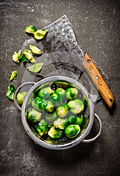 Fresh Brussels sprouts with a hatchet.