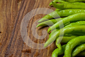 Fresh Bunch of green chili peppers on Chopper Board Close up Look