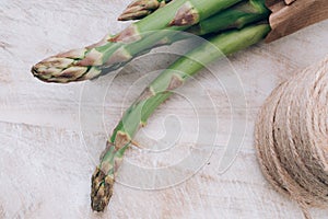 Fresh bunch of organic green asparagus spears on wooden table