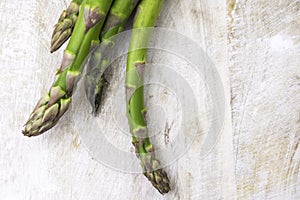 Fresh bunch of organic green asparagus spears on wooden table
