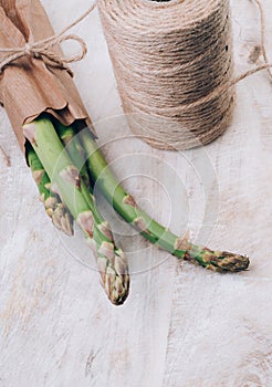 Fresh bunch of organic green asparagus spears on wooden table